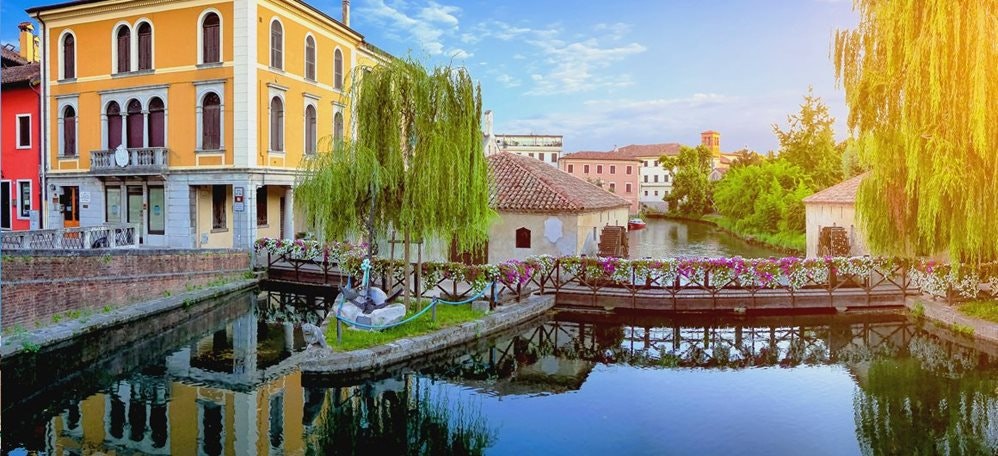 Portogruaro, an Italian town in the Veneto region , water channel and buildings