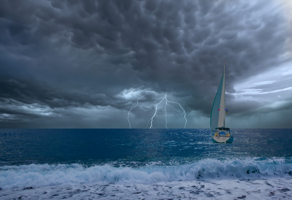 Плаваща лодка в бурно време със светкавици