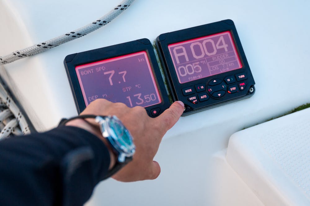 Modern sailing yacht controls - tridata and autopilot displays, showing speed, depth and course. Scotland sailing trip.