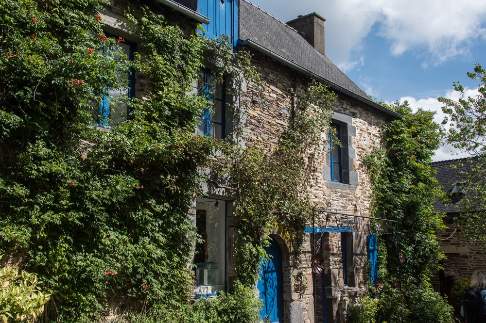 Traditional old stone houses in La Gacilly, covered with ivy.