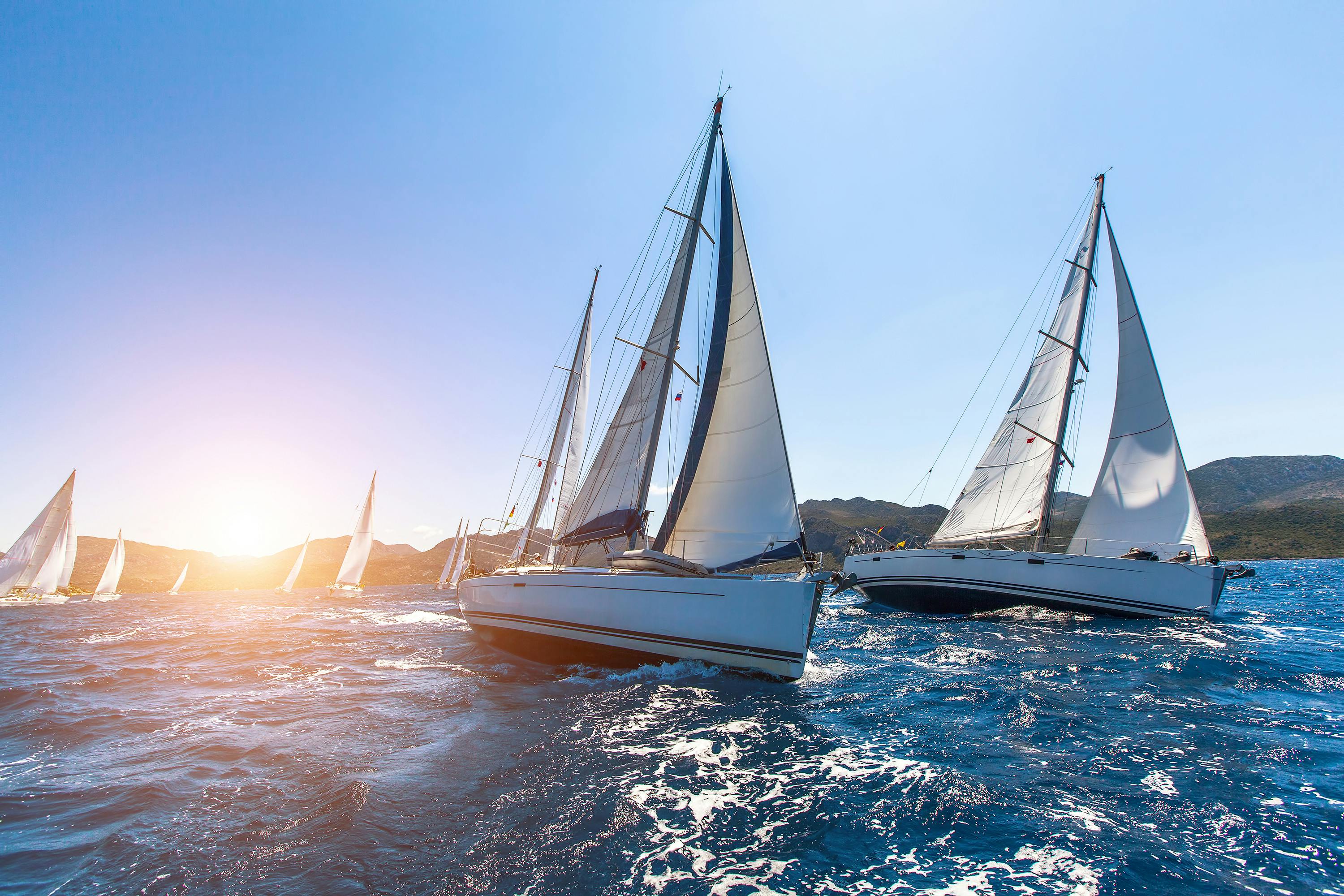 Luxury yachts in Sailing regattas. Sail in the wind through the waves by the sea.