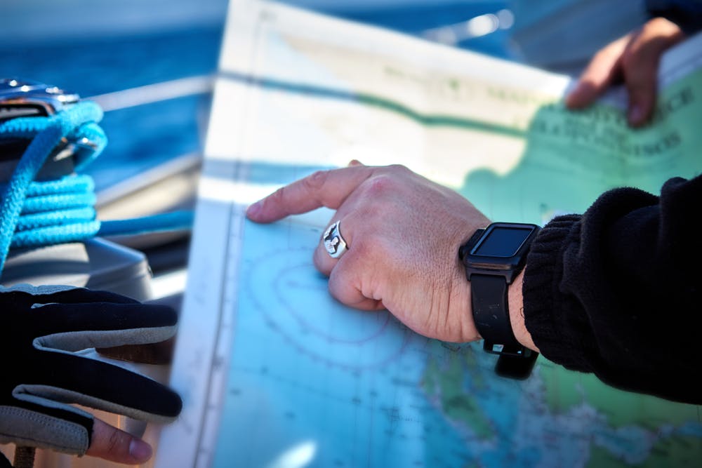 navigation with sea charts in the chart room on a sailing yacht