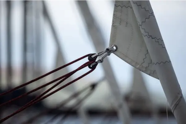 Make sure the genoa is well rolled up and you have at least two turns on the reins